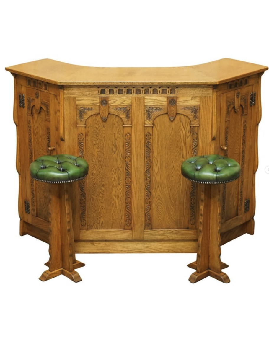 Carved oak home bar with green leather stools